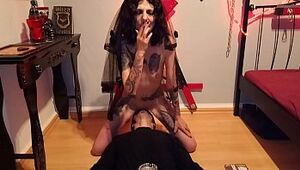 Licking blasphemic whore, while she smokes and rides a crucifix dildo